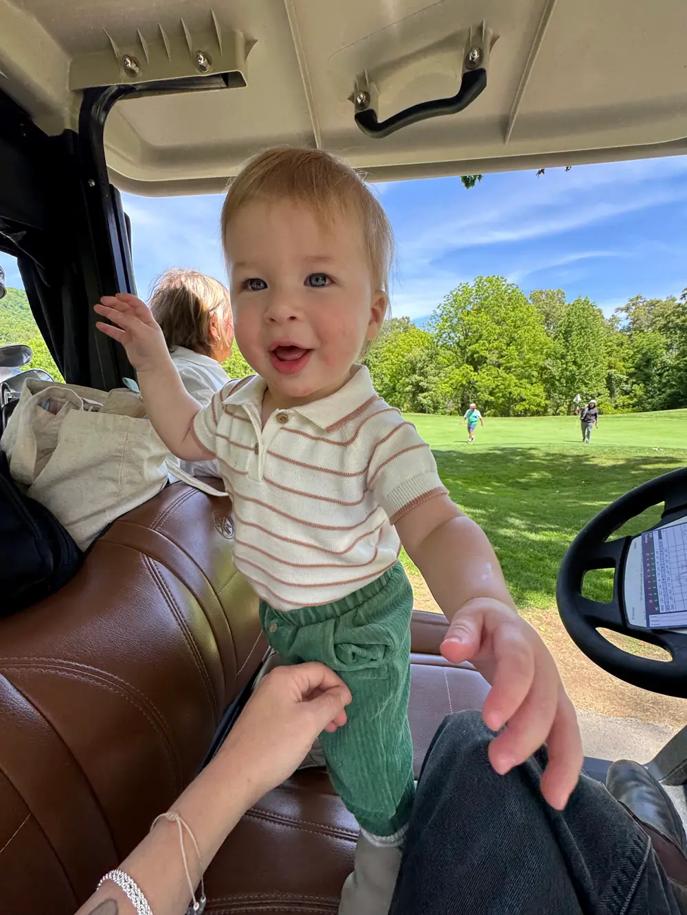 Malcolm riding along in the golf cart